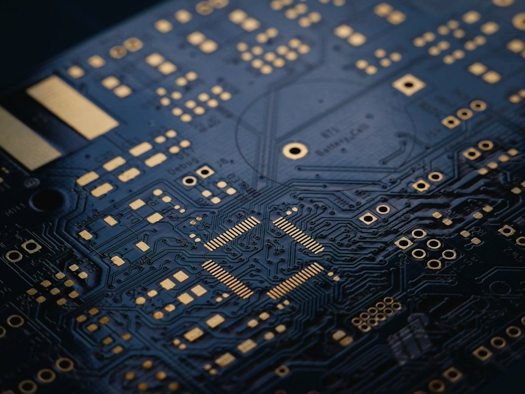 Close-up of a blue printed circuit board with gold contacts and traces