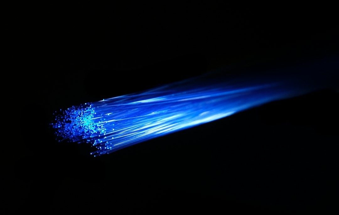 Blue glowing fiber-optic strands against a black background
