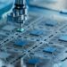 Microscope probe positioned over patterned microchip circuits