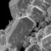 Microscopic view of angular ceramic-like particles and debris