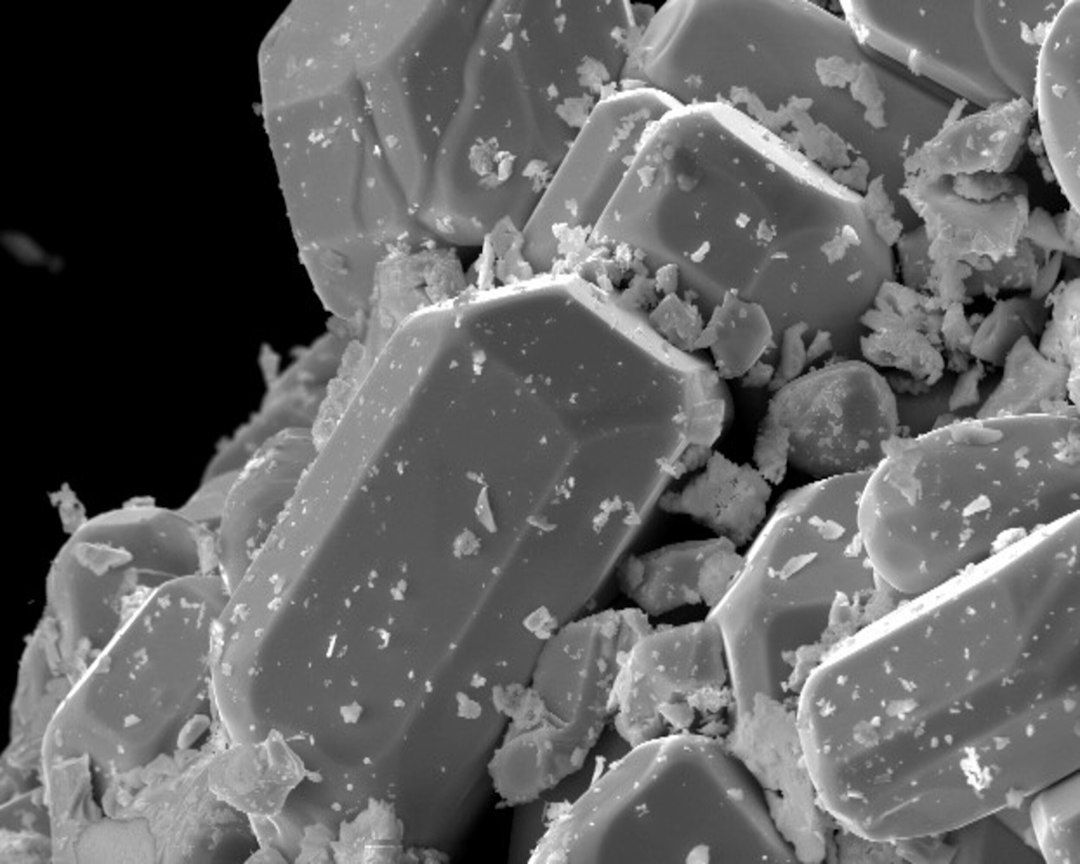 Microscopic view of angular ceramic-like particles and debris